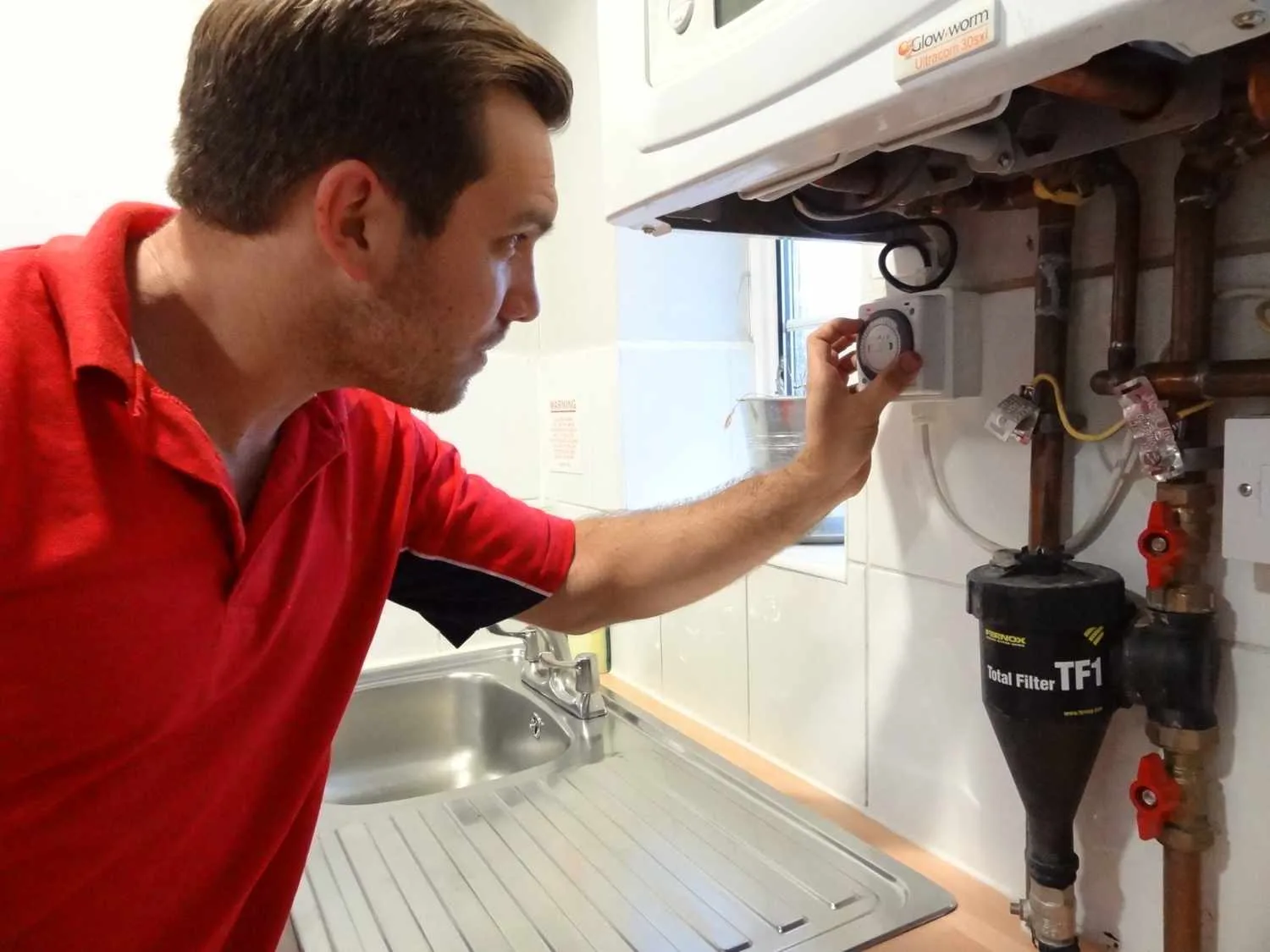 Greenwich Plumbers 247 boiler repair engineer working on a boiler in Greenwich